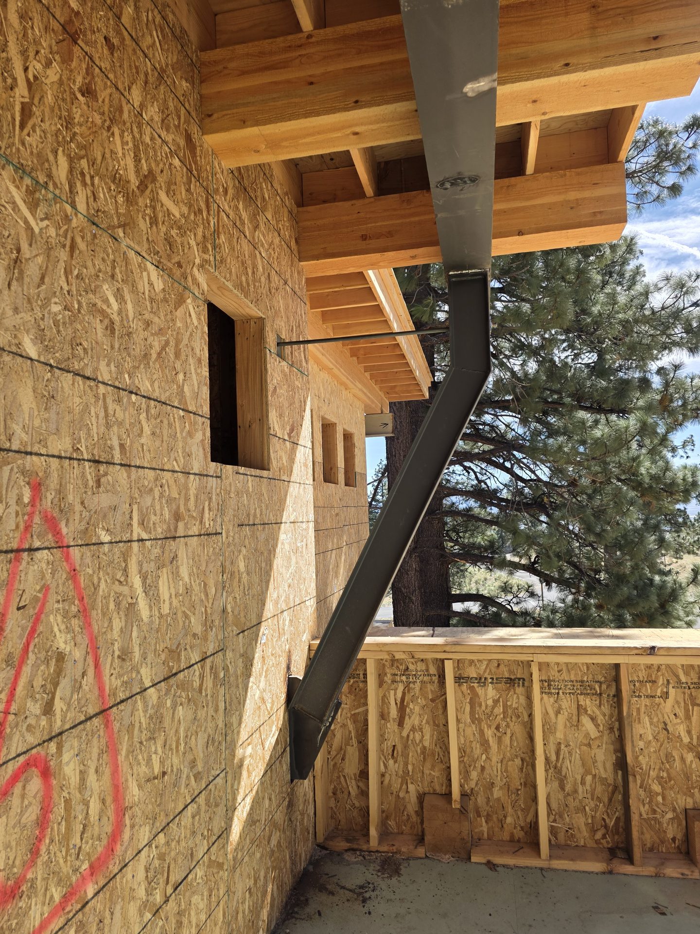 Steel kicker column bracing custom home exterior wall