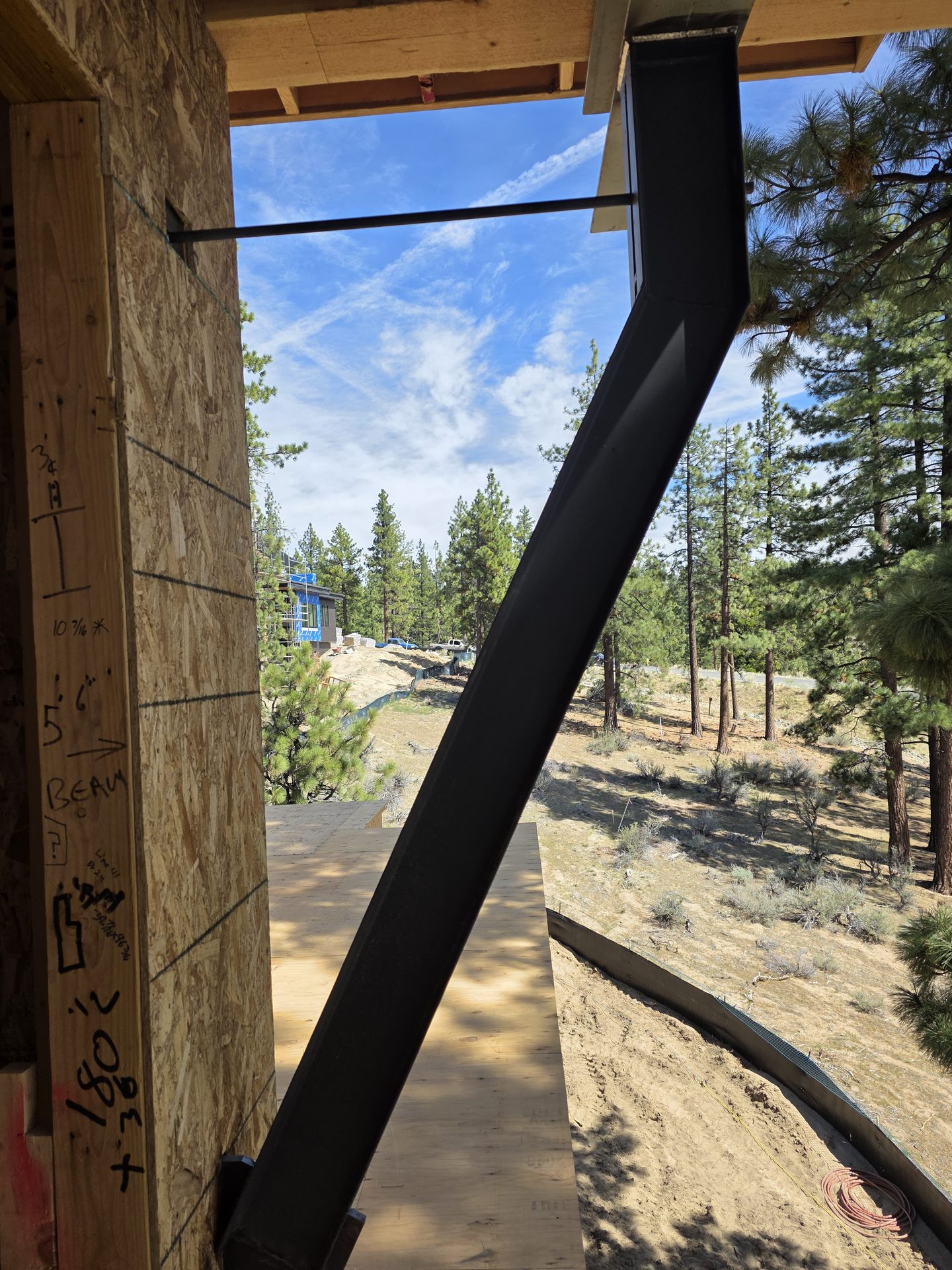 Angular black steel kicker column framing a Sierra mountain view at Knob Point residence